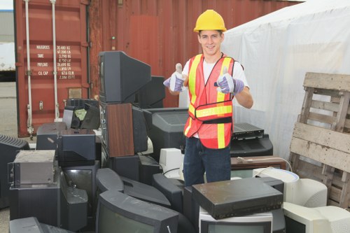 Workers in safety gear handling construction waste