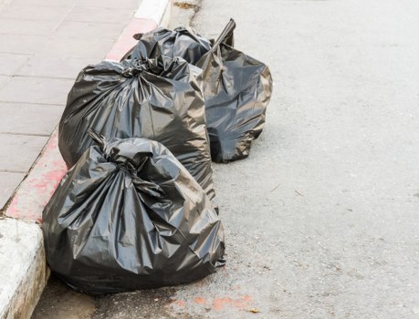 Construction workers managing waste on a building site