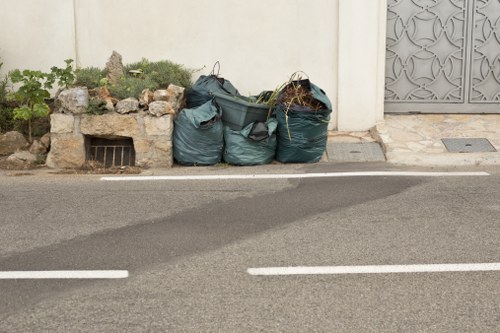 Construction workers managing builders waste clearance in Belsize Park