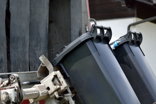 Expert waste removal process with recycling bins in use